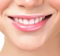 Person with white teeth smiling.