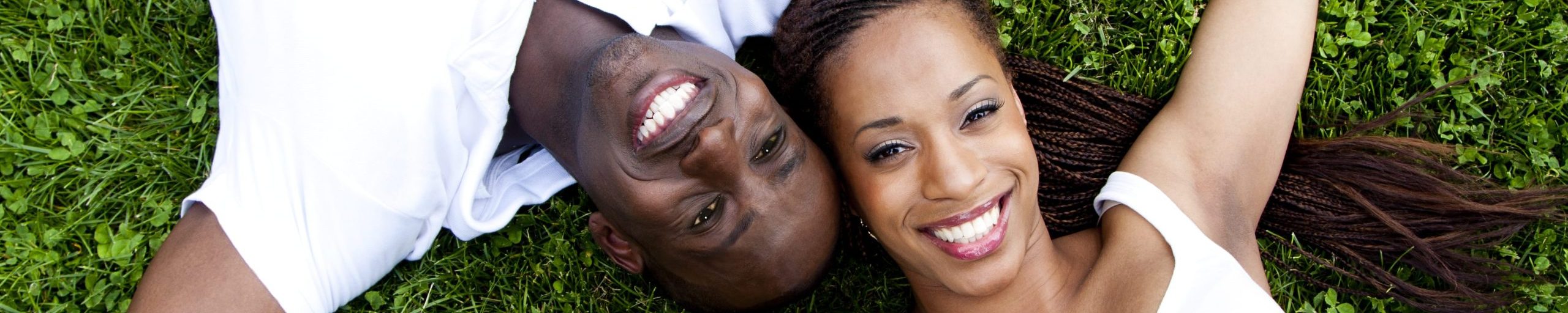 Two people with white teeth smiling.