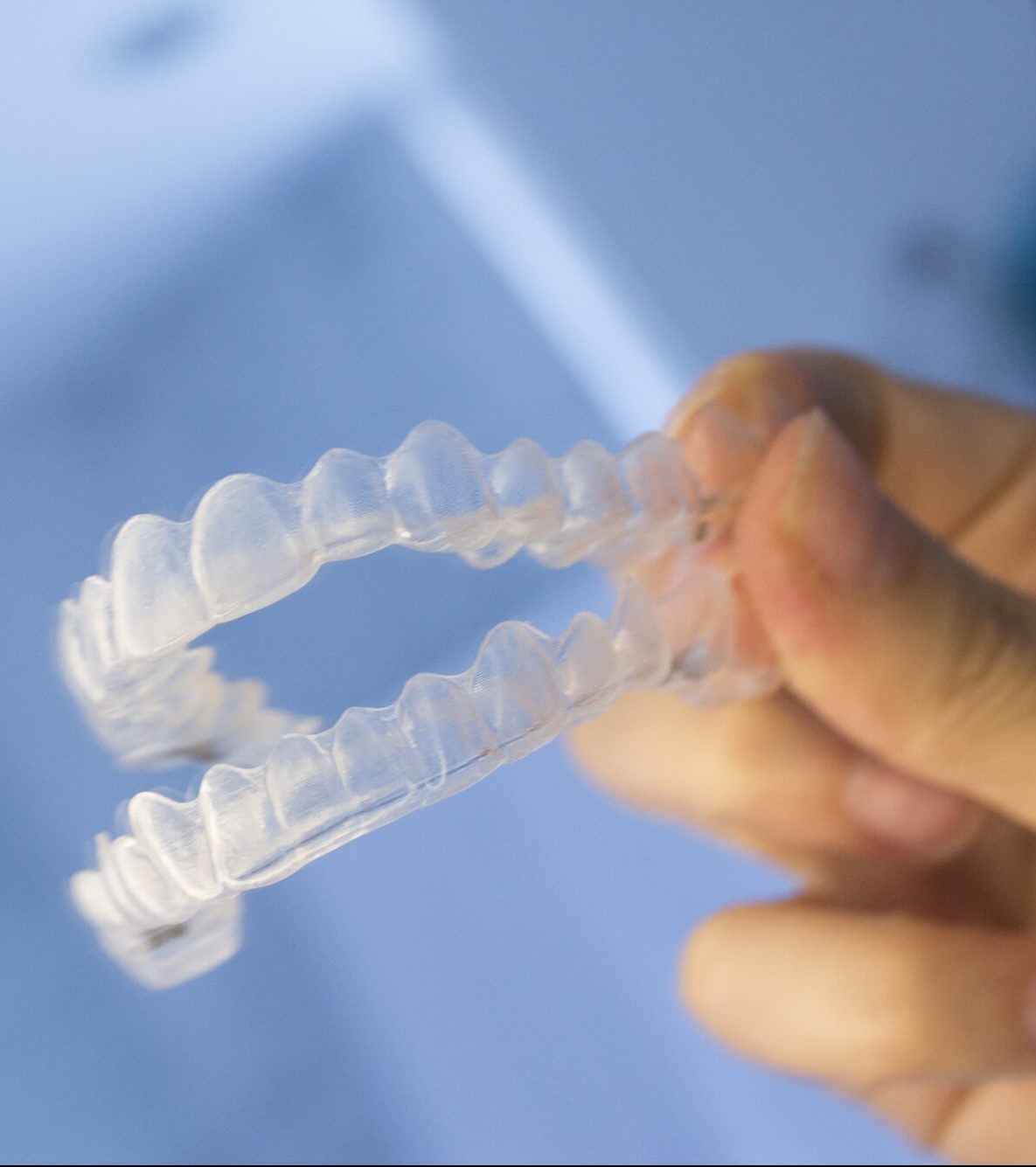 Person holding Invisalign braces.